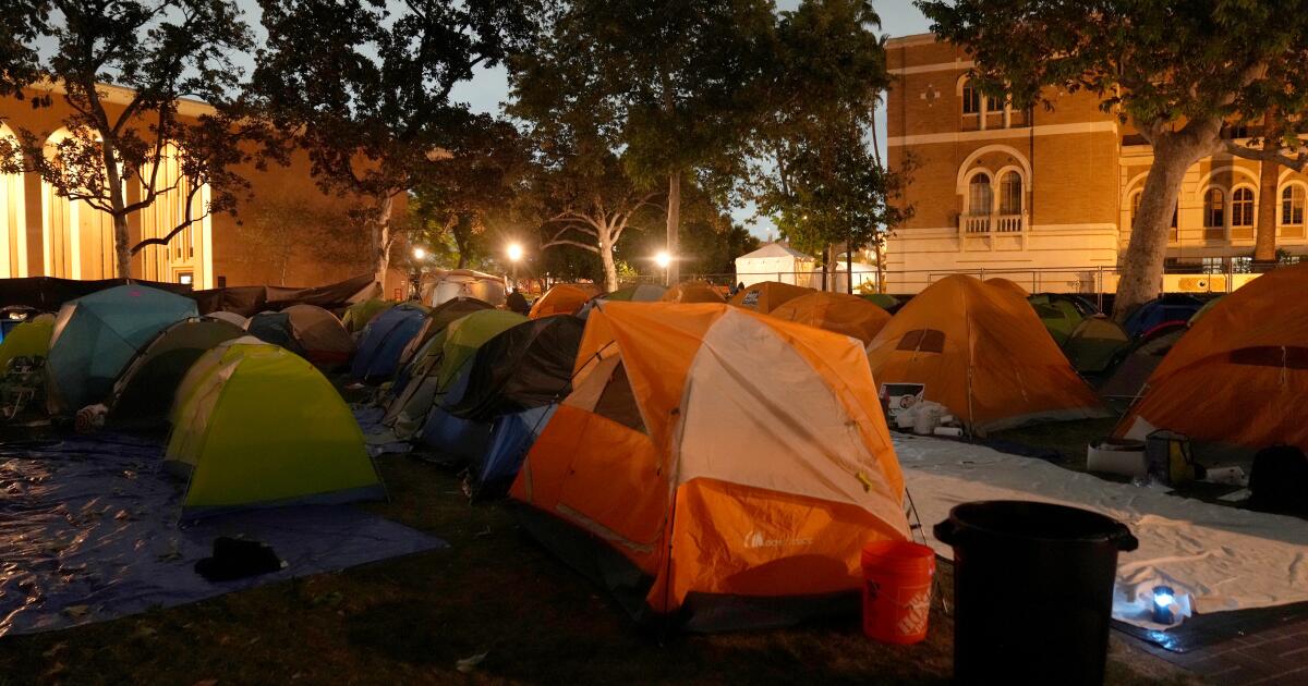 LAPD officers in riot gear swarm USC pro-Palestinian encampment, begin removing tents